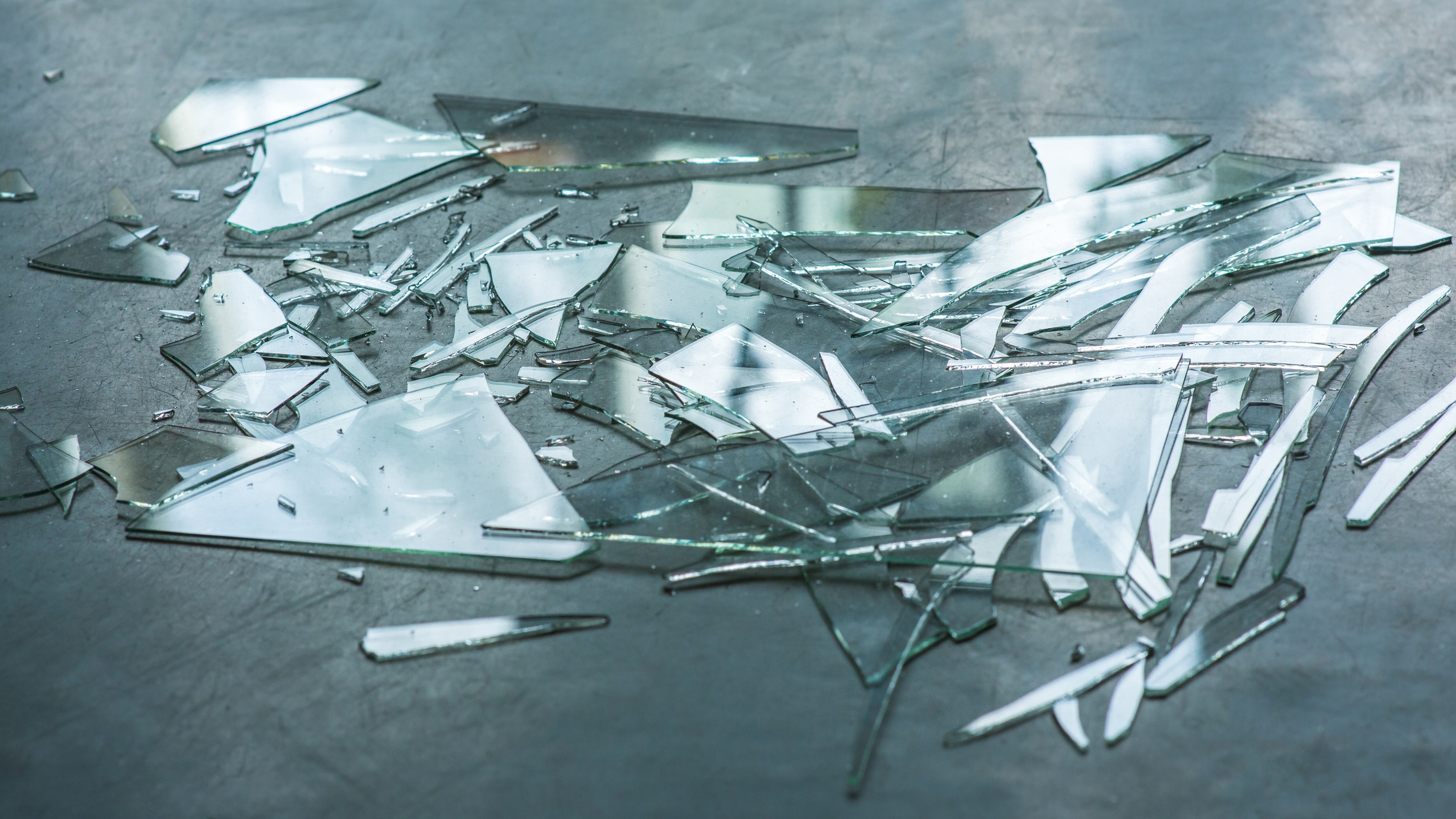 Broken glass, many pieces on the floor